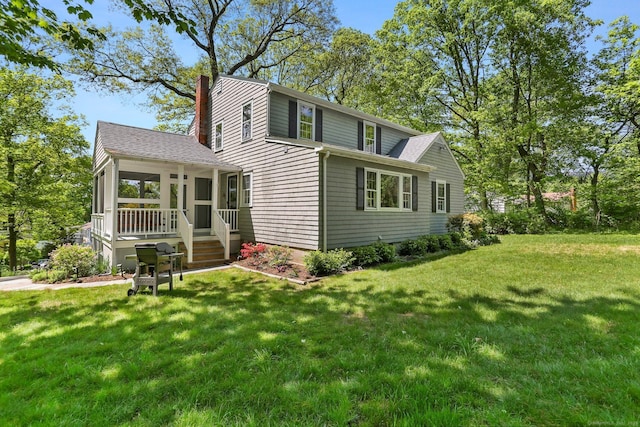 24 Richards Ln, Norwalk, CT 06851 - back of house featuring a chimney, a sunroom, a yard, and roof with shingles