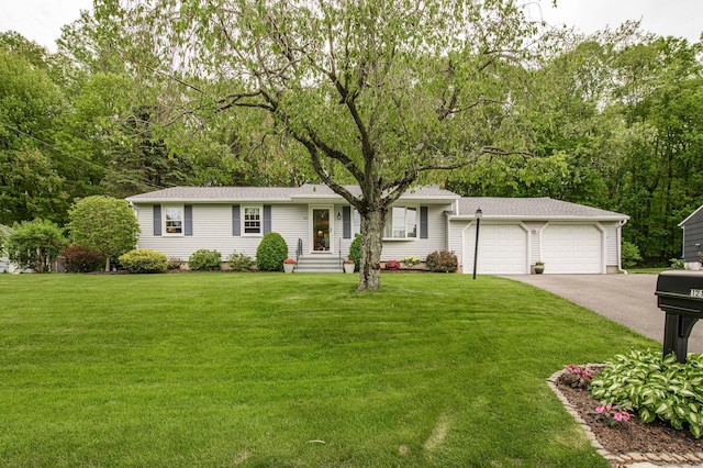 121 Dinatali Dr, Waterbury, CT 06705 - view of front of home featuring an attached garage, asphalt driveway, a front yard, and roof with shingles