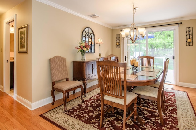 121 Dinatali Dr, Waterbury, CT 06705 - dining space featuring baseboards, a chandelier, ornamental molding, and light wood-style flooring