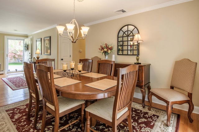 121 Dinatali Dr, Waterbury, CT 06705 - dining space featuring wood finished floors, ornamental molding, a chandelier, and baseboards
