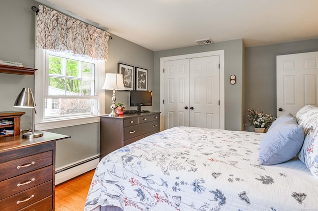 121 Dinatali Dr, Waterbury, CT 06705 - bedroom with baseboard heating, a closet, and light wood-type flooring