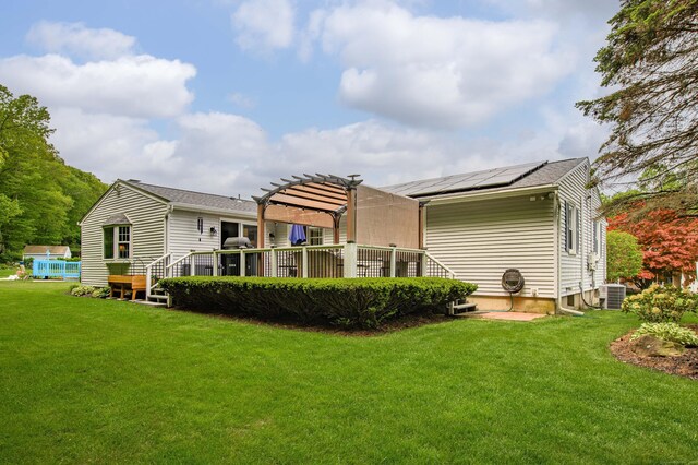 121 Dinatali Dr, Waterbury, CT 06705 - back of property with a pergola, a lawn, and a wooden deck
