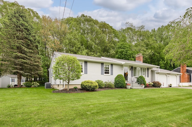 121 Dinatali Dr, Waterbury, CT 06705 - view of front facade featuring central AC, a front lawn, a garage, and a chimney