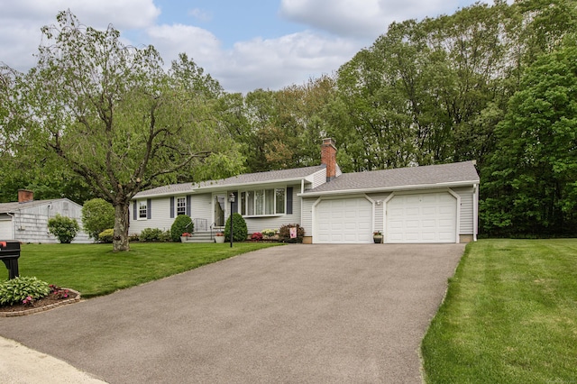 121 Dinatali Dr, Waterbury, CT 06705 - view of front of property with driveway, a garage, a chimney, a front yard, and a shingled roof
