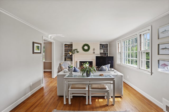 76 Glenbrook Rd, West Hartford, CT 06107 - living room featuring wood finished floors, ornamental molding, a fireplace, and built in shelves
