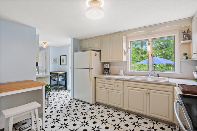 76 Glenbrook Rd, West Hartford, CT 06107 - kitchen featuring freestanding refrigerator, light countertops, cream cabinets, and open shelves