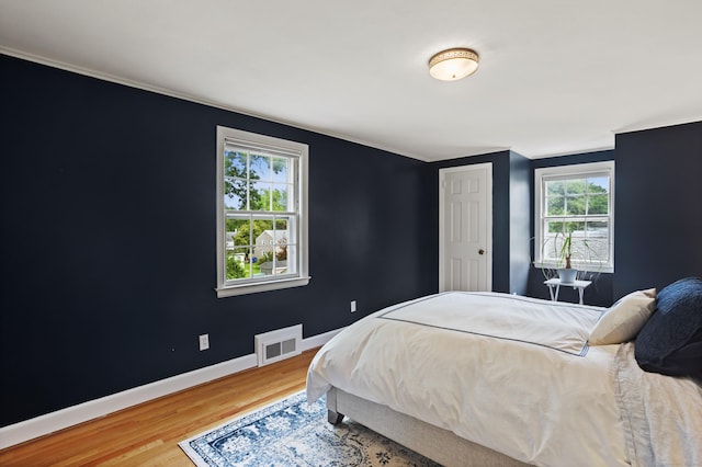 76 Glenbrook Rd, West Hartford, CT 06107 - bedroom with wood finished floors, multiple windows, and ornamental molding