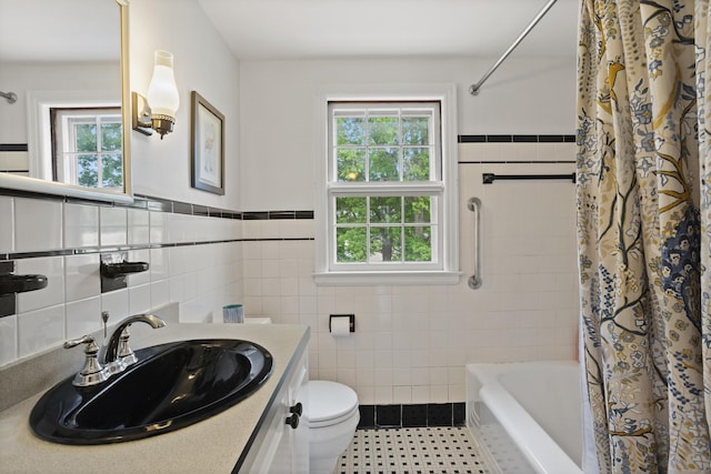 76 Glenbrook Rd, West Hartford, CT 06107 - bathroom featuring plenty of natural light, tile walls, vanity, shower / bath combo, and wainscoting
