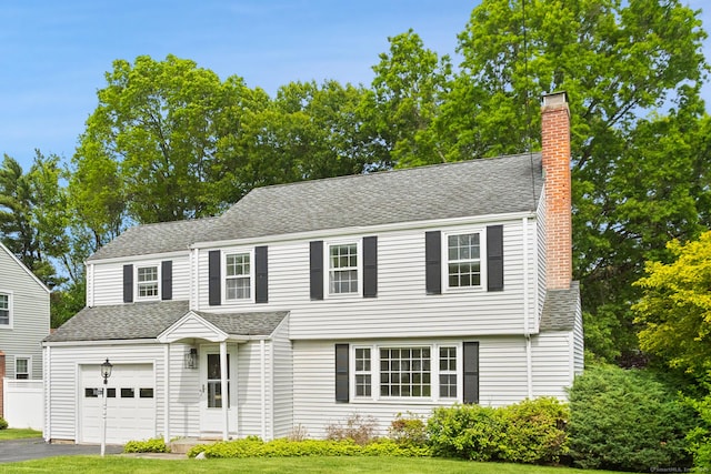 76 Glenbrook Rd, West Hartford, CT 06107 - colonial-style house with a chimney, a front yard, driveway, and a shingled roof