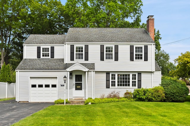 76 Glenbrook Rd, West Hartford, CT 06107 - view of front of home with a chimney, driveway, a garage, and roof with shingles