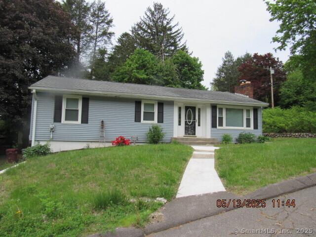 single story home with a chimney and a front lawn