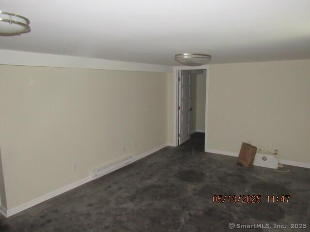 unfurnished room featuring baseboards