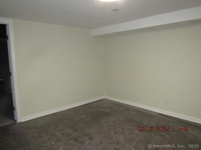 spare room with baseboards