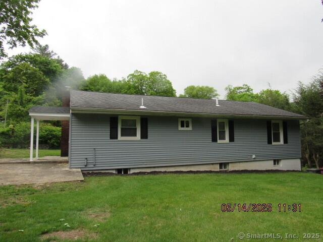 8 Noble Ave, Naugatuck, CT 06770 - rear view of house with a lawn and a patio area