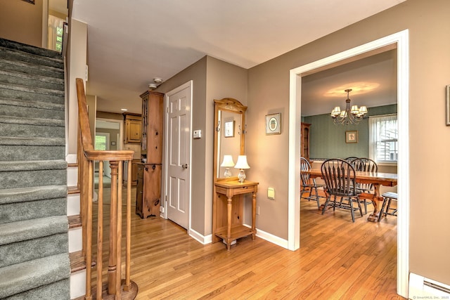 980 Mount Carmel Ave, Hamden, CT 06518 - foyer featuring stairs, light wood-style floors, a chandelier, baseboards, and a baseboard radiator