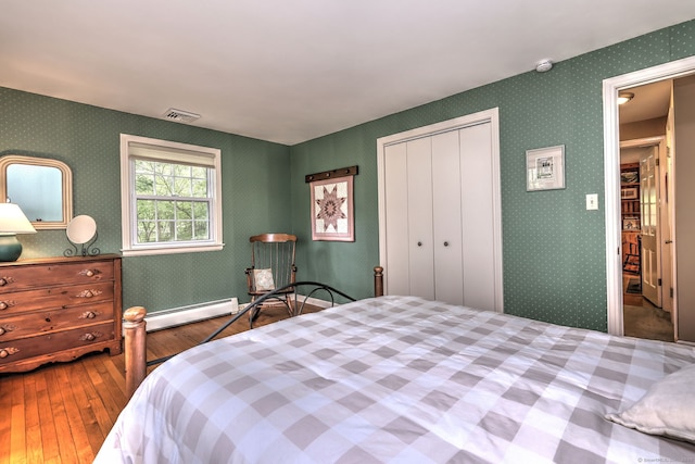 980 Mount Carmel Ave, Hamden, CT 06518 - bedroom with baseboard heating, hardwood / wood-style floors, and a closet