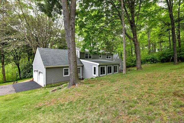 980 Mount Carmel Ave, Hamden, CT 06518 - view of front of home featuring asphalt driveway, a front yard, a shingled roof, and a garage