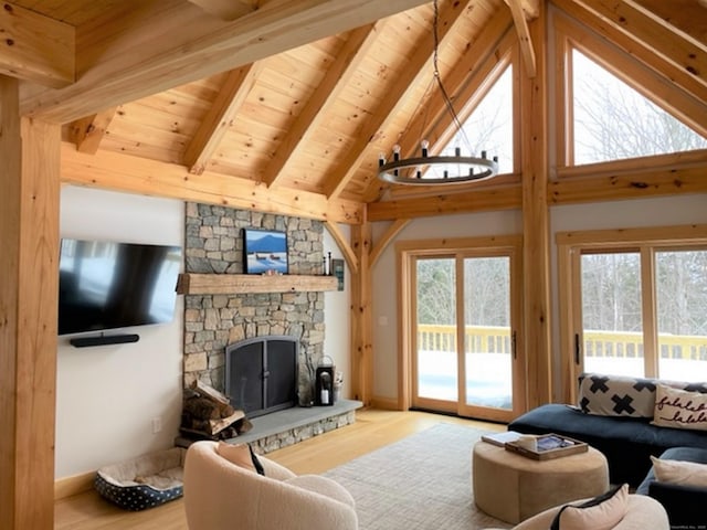 24 Calhoun St, Washington, CT 06794 - living area with wood finished floors, wooden ceiling, healthy amount of natural light, and a stone fireplace