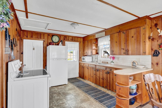 27 Barnes Rd, Old Saybrook, CT 06475 - kitchen featuring white appliances, open shelves, wooden walls, light countertops, and backsplash