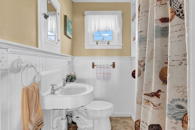 27 Barnes Rd, Old Saybrook, CT 06475 - bathroom featuring wainscoting, healthy amount of natural light, toilet, curtained shower, and tile patterned flooring