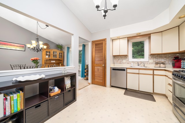 kitchen featuring stainless steel appliances, a chandelier, vaulted ceiling, light countertops, and decorative backsplash