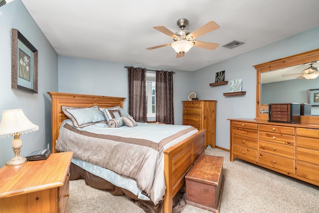 bedroom featuring light carpet and a ceiling fan