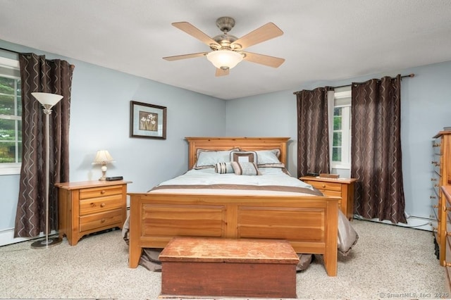 bedroom with light colored carpet and a ceiling fan