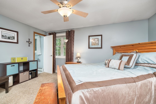 carpeted bedroom featuring baseboard heating and a ceiling fan