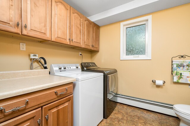 clothes washing area featuring a baseboard heating unit and washer and clothes dryer