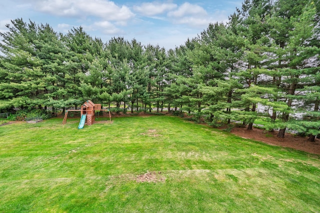view of grassy yard featuring a playground