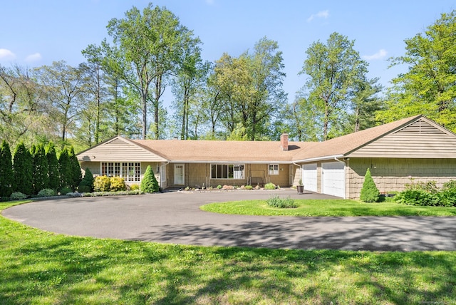 1 Penwood Rd, Bloomfield, CT 06002 - single story home with an attached garage, a chimney, driveway, and a front yard