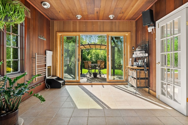 1 Penwood Rd, Bloomfield, CT 06002 - entryway featuring wood walls, tile patterned flooring, wooden ceiling, and plenty of natural light