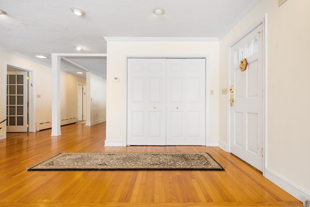 1 Penwood Rd, Bloomfield, CT 06002 - foyer entrance with ornamental molding, wood finished floors, baseboards, a baseboard radiator, and recessed lighting