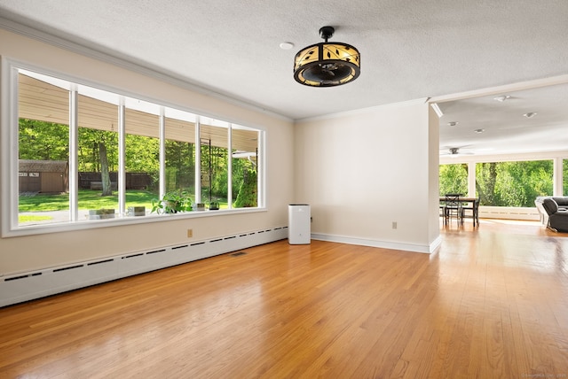 1 Penwood Rd, Bloomfield, CT 06002 - unfurnished room featuring ornamental molding, baseboard heating, wood finished floors, baseboards, and a textured ceiling
