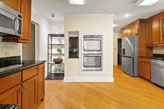 1 Penwood Rd, Bloomfield, CT 06002 - kitchen featuring stainless steel appliances, light wood-type flooring, brown cabinets, ornamental molding, and decorative backsplash