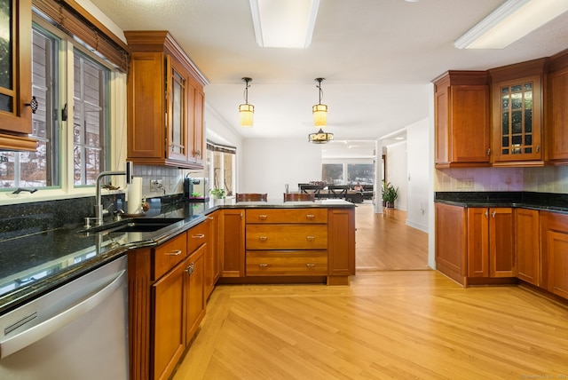 1 Penwood Rd, Bloomfield, CT 06002 - kitchen with stainless steel dishwasher, a sink, backsplash, and light wood-style floors