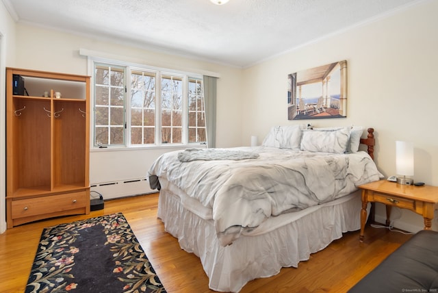 1 Penwood Rd, Bloomfield, CT 06002 - bedroom with a baseboard heating unit, crown molding, light wood-style floors, and a textured ceiling