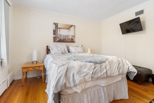 1 Penwood Rd, Bloomfield, CT 06002 - bedroom with crown molding, wood finished floors, a baseboard radiator, and baseboards