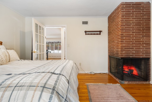 1 Penwood Rd, Bloomfield, CT 06002 - bedroom featuring wood finished floors, a brick fireplace, baseboards, and crown molding
