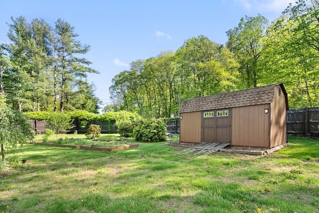 1 Penwood Rd, Bloomfield, CT 06002 - view of yard featuring a storage shed, a vegetable garden, and an outbuilding