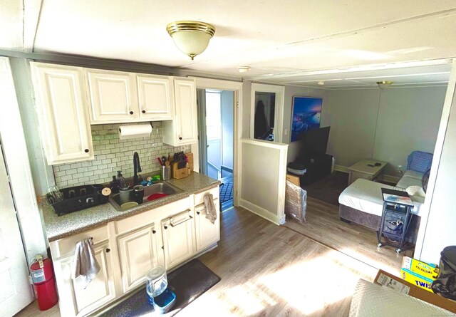 546 Washington Ave, West Haven, CT 06516 - kitchen with a sink, backsplash, wood finished floors, and light countertops