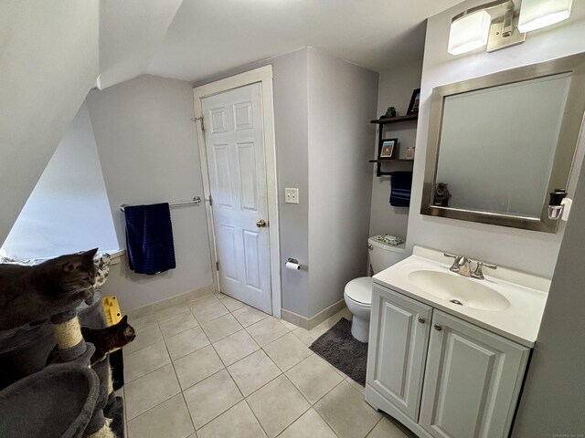 546 Washington Ave, West Haven, CT 06516 - bathroom with toilet, vanity, tile patterned floors, lofted ceiling, and baseboards