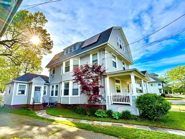 546 Washington Ave, West Haven, CT 06516 - view of front of property featuring entry steps, roof mounted solar panels, covered porch, a gambrel roof, and a shingled roof