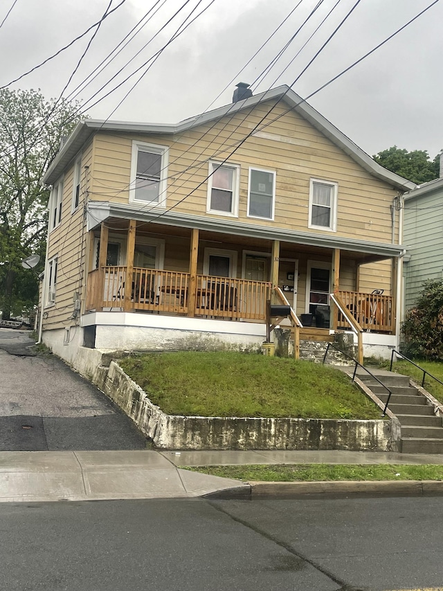 32 Spring St, Danbury, CT 06810 - view of front of home featuring covered porch and a front lawn
