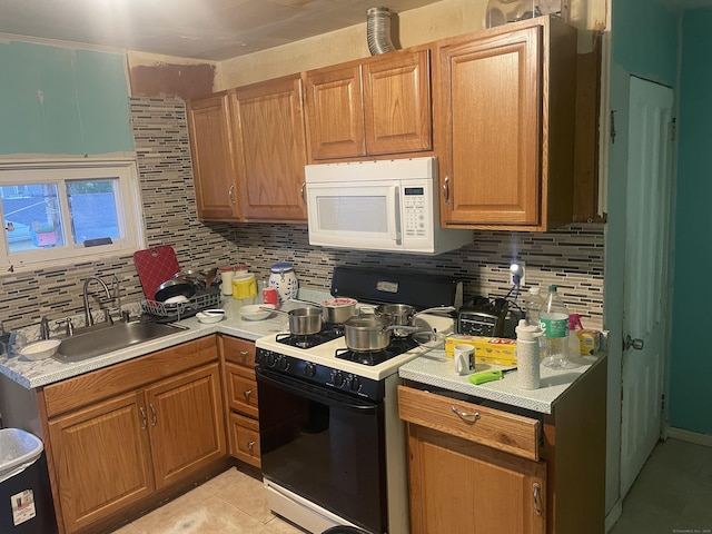 32 Spring St, Danbury, CT 06810 - kitchen with gas range, white microwave, a sink, and tasteful backsplash