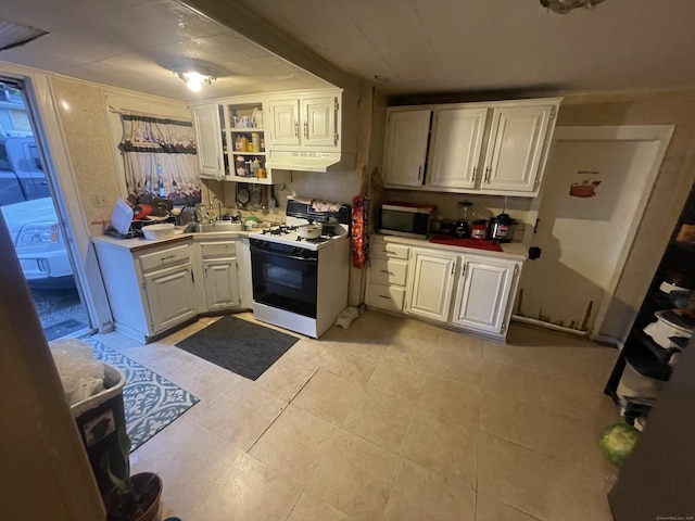 32 Spring St, Danbury, CT 06810 - kitchen with range with gas stovetop, under cabinet range hood, stainless steel microwave, white cabinets, and light countertops