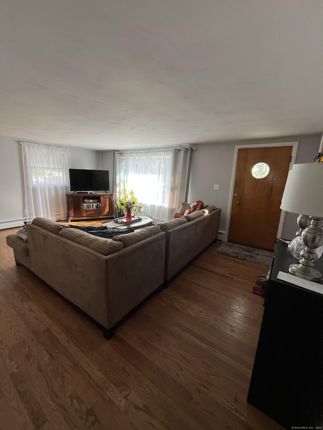 living area with wood finished floors and baseboard heating