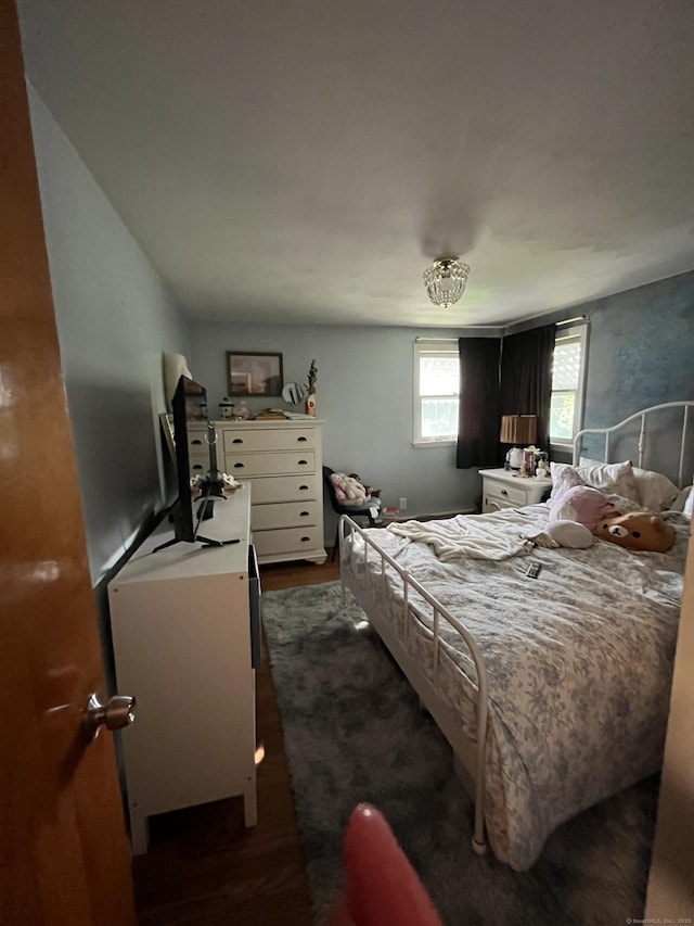 bedroom with dark wood-type flooring