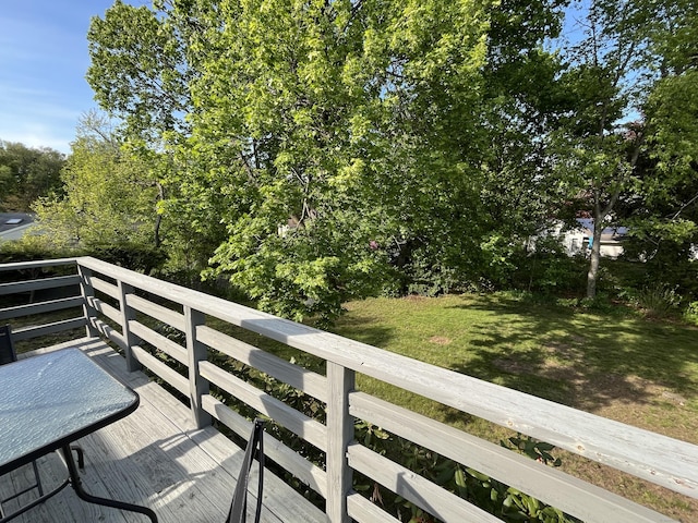wooden deck with a lawn