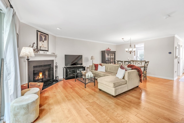 123 Old Belden Hill Rd Apt 41, Norwalk, CT 06850 - living room with light wood-style flooring, a fireplace with flush hearth, a chandelier, crown molding, and baseboards